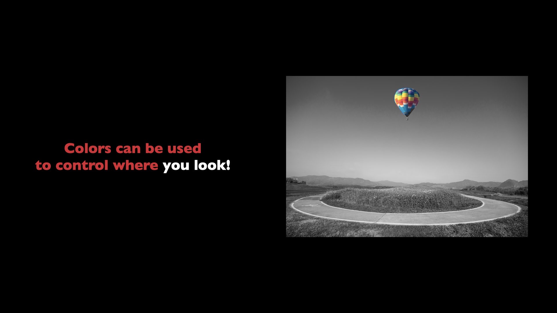 Slide with a black-and-white landscape where only a hot air balloon is in colour — it draws the eye immediately.